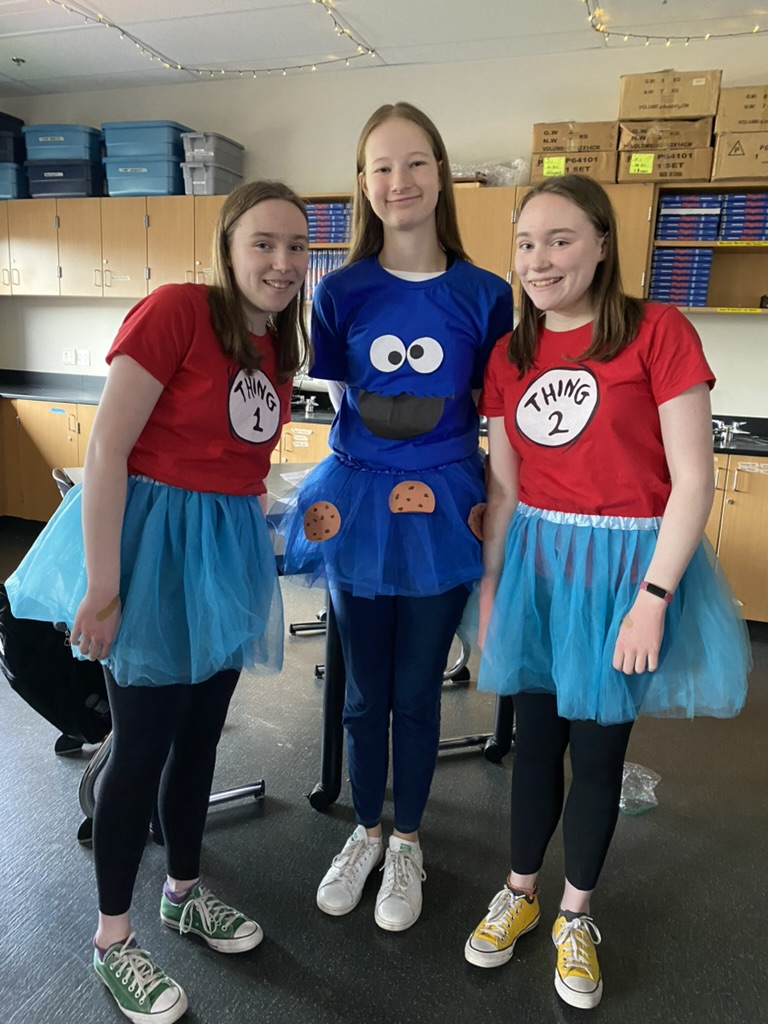 Three girls in Halloween costumes, all in wearing blue tutus.