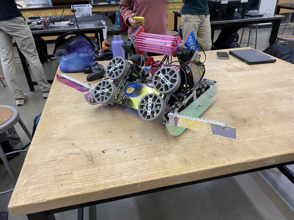 A pink and purple robot on a table.