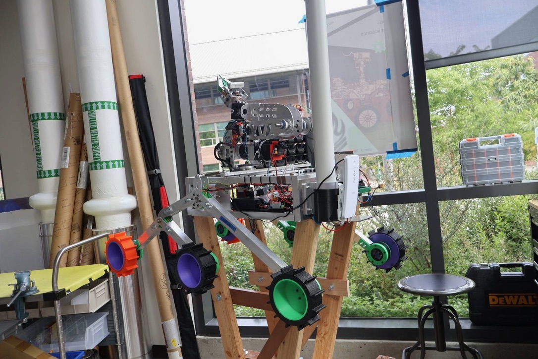 A rover on a wooden cart in front of a window.